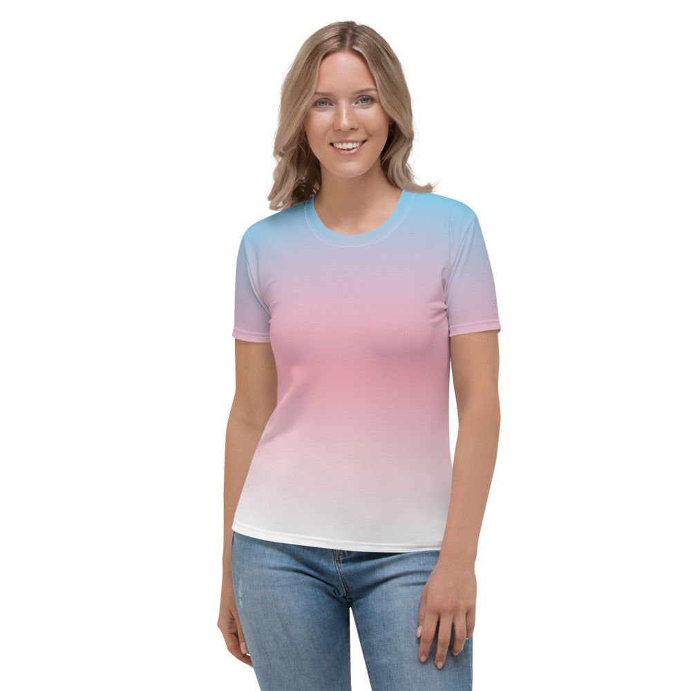 A woman wears a fitted t-shirt with the three colours of the trans pride flag made into a gradient, with blue fading into pink and then into white from top to bottom